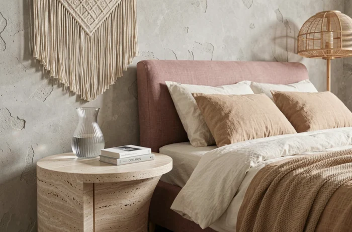 Chambre contemporaine avec tête de lit en lin rose, table de chevet en travertin et décoration murale en macramé